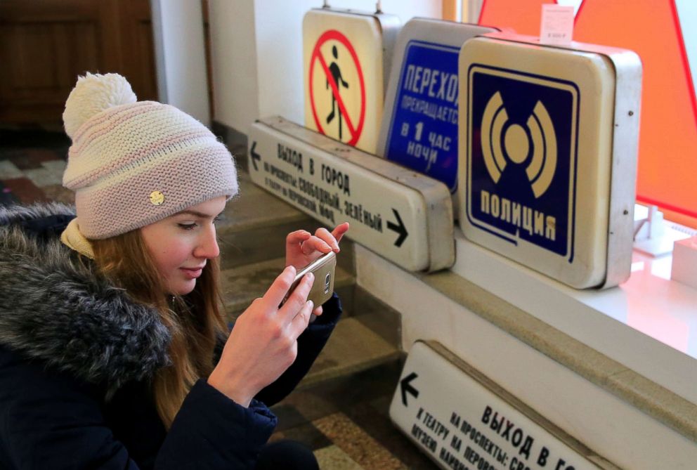 PHOTO: A visitor takes pictures of retro signboards after Moscow metro launched sales of the decommissioned passenger signs at a gift shop in Moscow, Dec. 25, 2018.