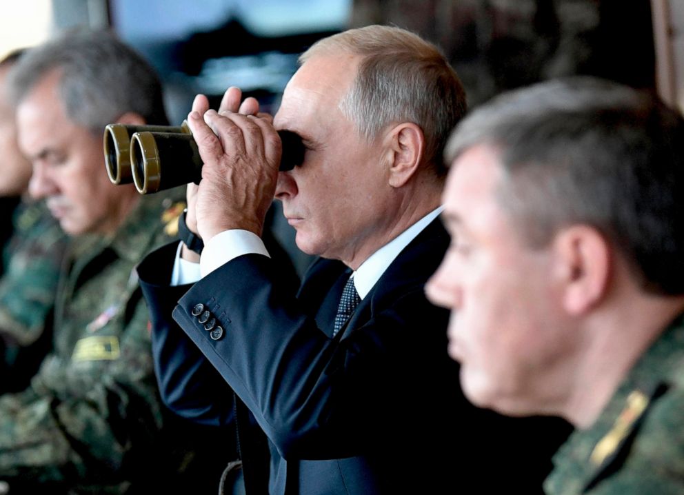 PHOTO: Russian President Vladimir Putin looks through a binocular as he visits the training ground "Telemba", during the military exercises Vostok 2018 in Eastern Siberia, Russia, Sept. 13, 2018.