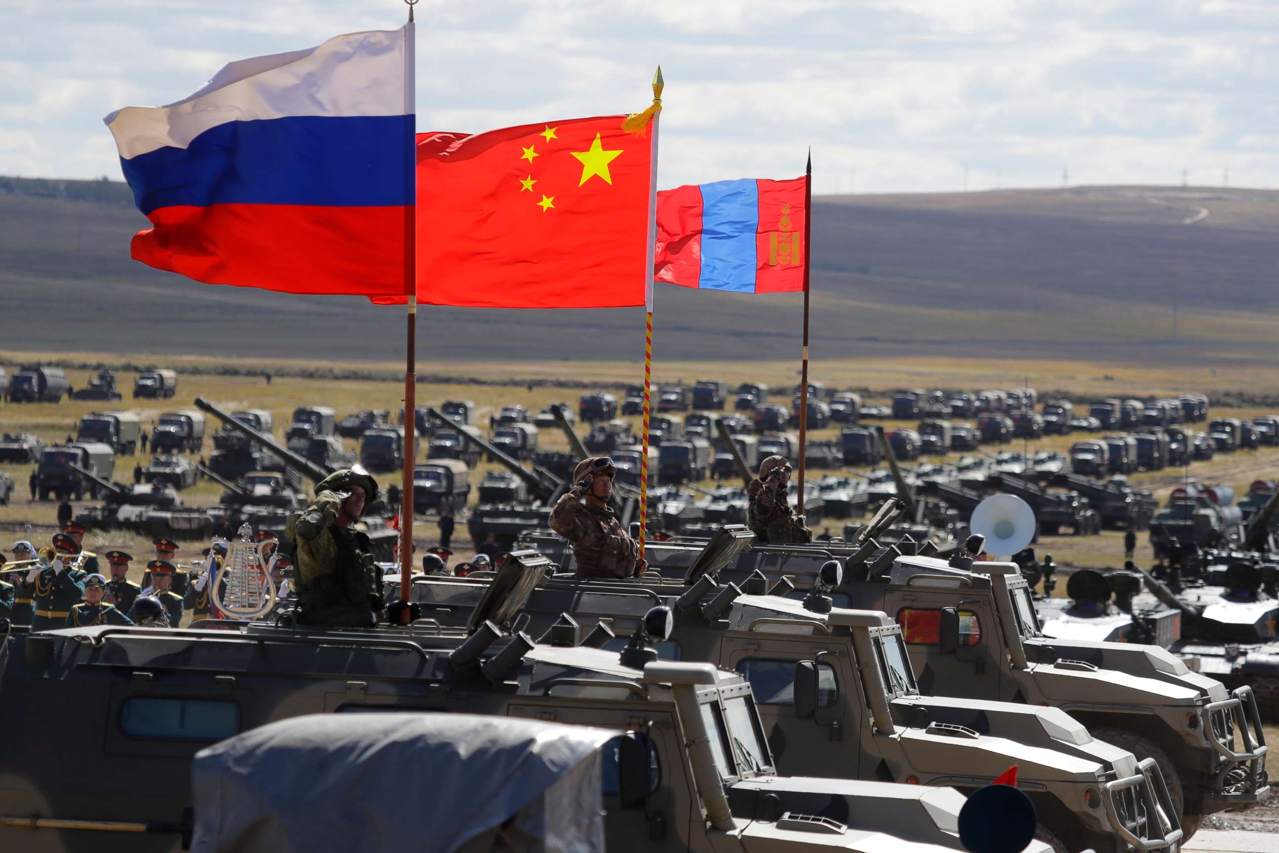 PHOTO: Russian, Chinese and Mongolian national flags set atop armored vehicles during military exercises in Eastern Siberia, Russia, Sept. 13, 2018.