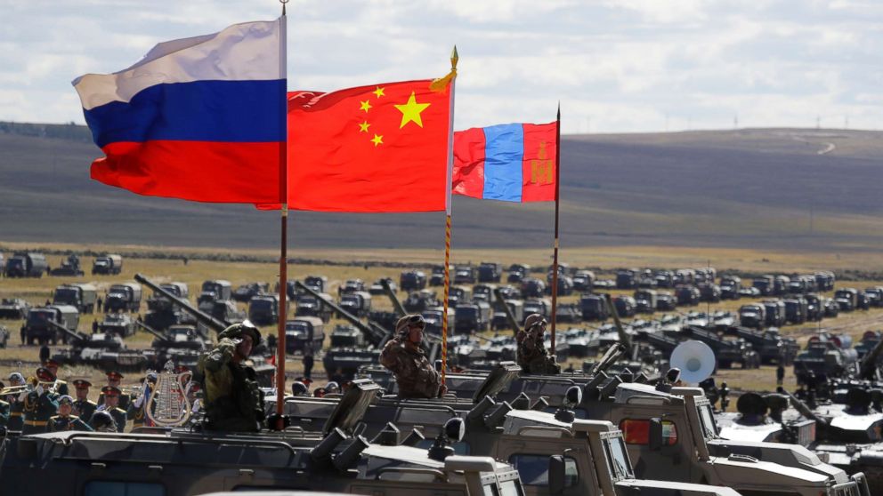 Russian, Chinese and Mongolian national flags set atop armored vehicles during military exercises in Eastern Siberia, Russia, Sept. 13, 2018.