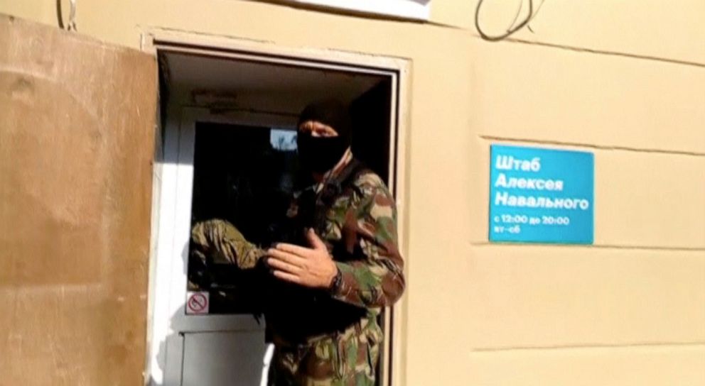 PHOTO: A masked law enforcement officer addresses journalists during a raid in a local office of Kremlin critic Alexei Navalny in Perm, Russia, Sept. 12, 2019, in a still image taken from a video.