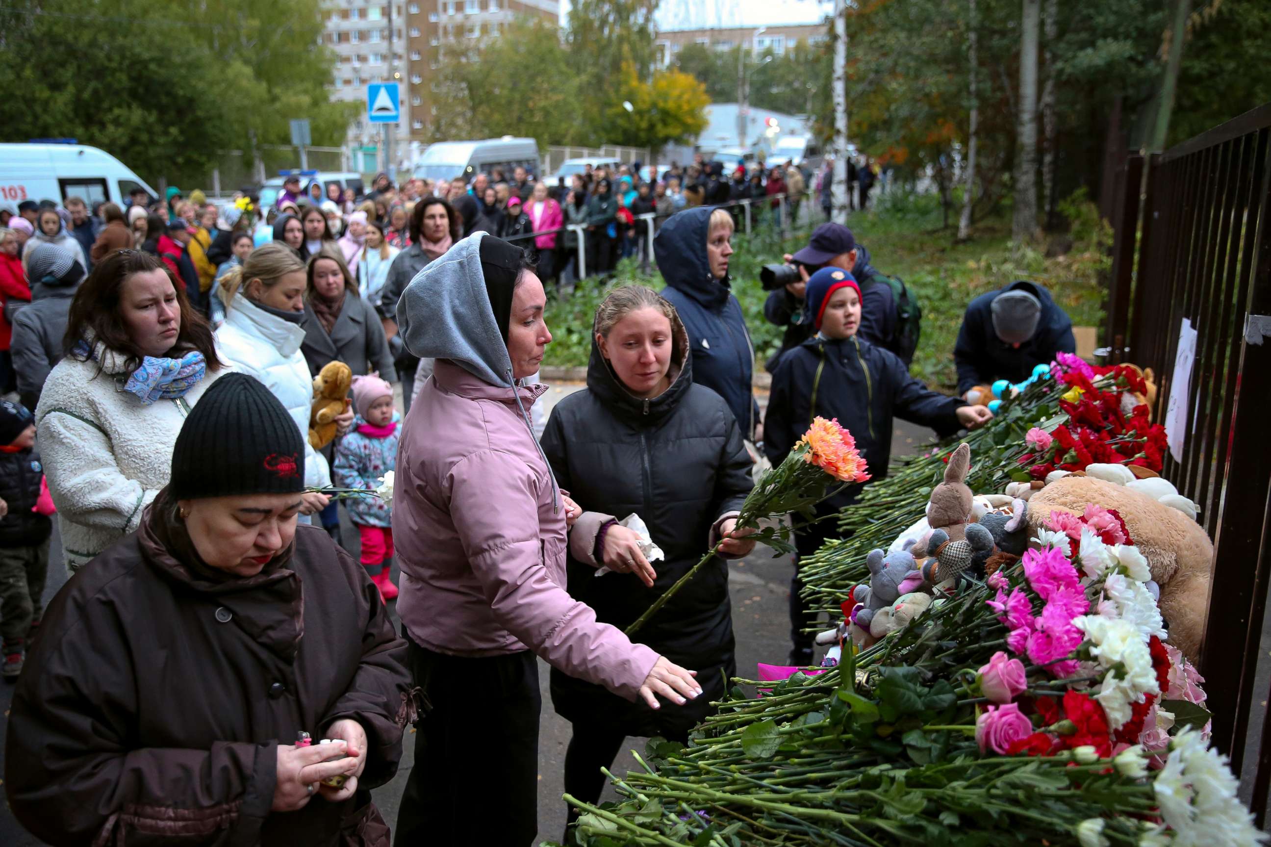 PHOTO: People gather to lay flowers, put toys and light candles in memory of victims of the shooting at school No. 88 in Izhevsk, Russia, Sept. 26, 2022.