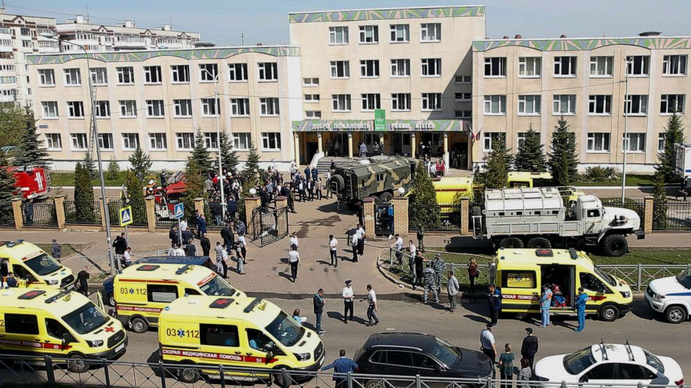 PHOTO: Ambulances and police cars and a truck are parked at a school after a shooting in Kazan, Russia, Tuesday, May 11, 2021. 
