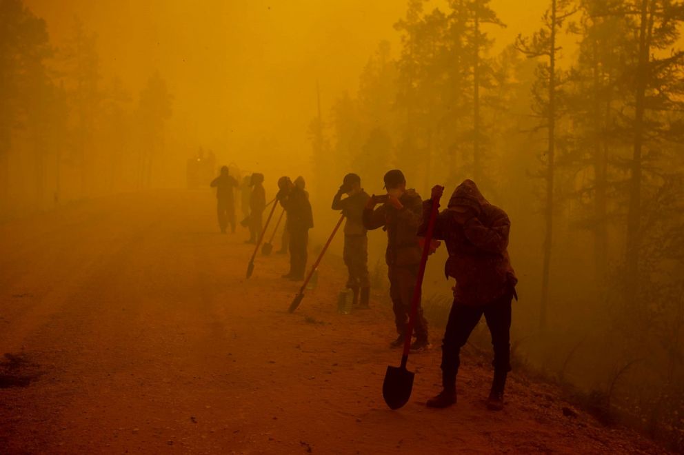 PHOTO: Volunteers pause while working at the scene of forest fire near Kyuyorelyakh village at Gorny Ulus area west of Yakutsk, in Russia, Aug. 7, 2021.