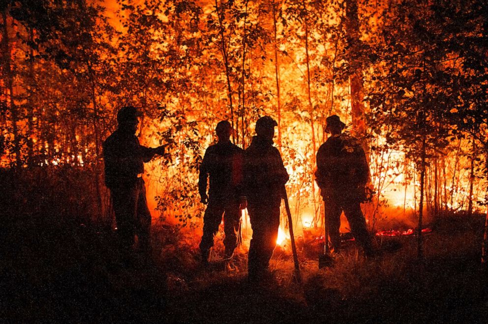 PHOTO: Firefighters work at the scene of forest fire near Kyuyorelyakh village at Gorny Ulus area, west of Yakutsk, in Russia, Aug. 5, 2021.