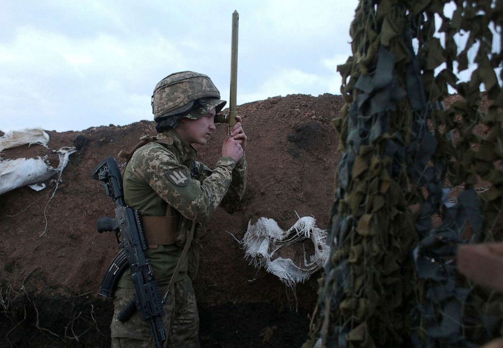 PHOTO: A Ukrainian serviceman uses a periscope in a trench as he stands at his post on the frontline with Russia backed separatists near the town of Zolote, in the Lugansk region on April 8, 2021.