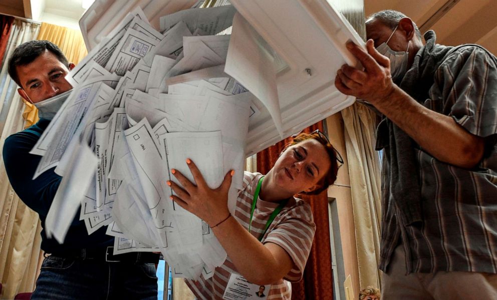 PHOTO: Members of a local electoral commission empty a ballot box at a polling station after a nationwide vote on constitutional reforms, in Moscow, July 1, 2020.