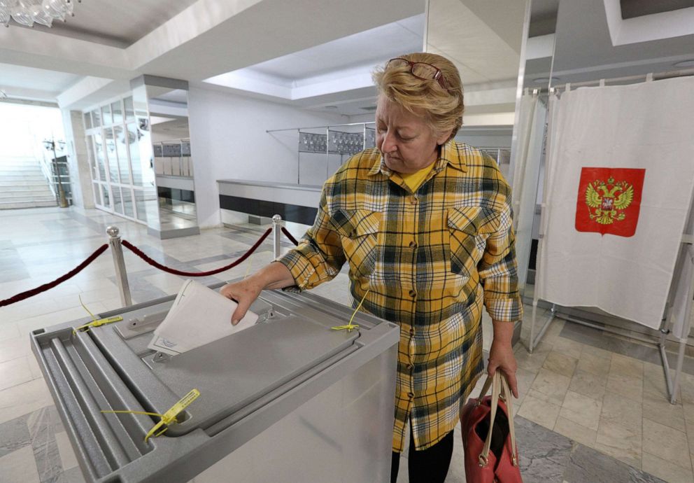 PHOTO: A woman casts her ballot during the first day of a referendum on the joining of Russian-controlled regions of Ukraine to Russia, in Sevastopol, Crimea, Sept. 23, 2022.
