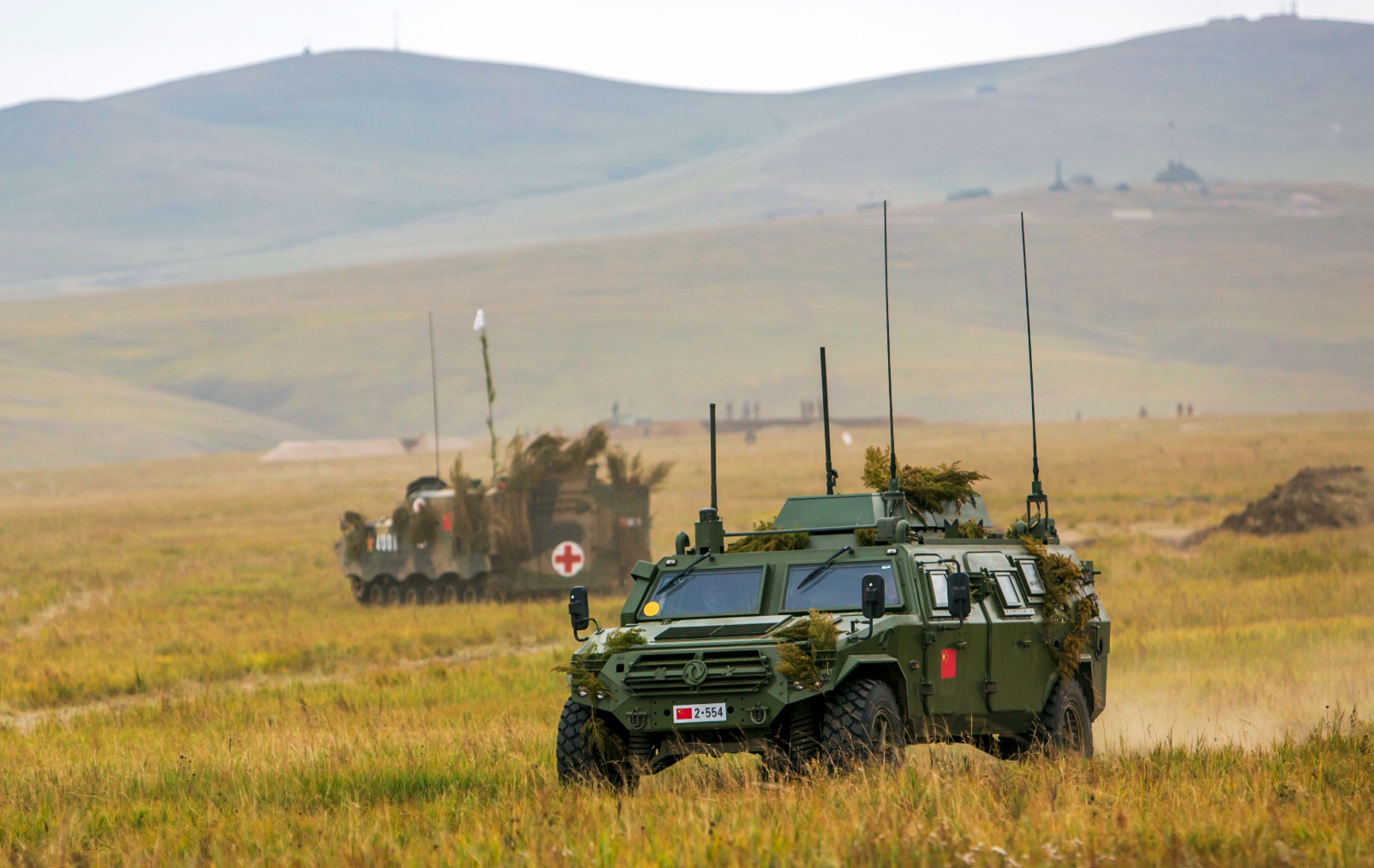 PHOTO: Chinese military vehicles through a field in Chita, Eastern Siberia, during the Vostok 2018 exercises, Sept. 11, 2018.