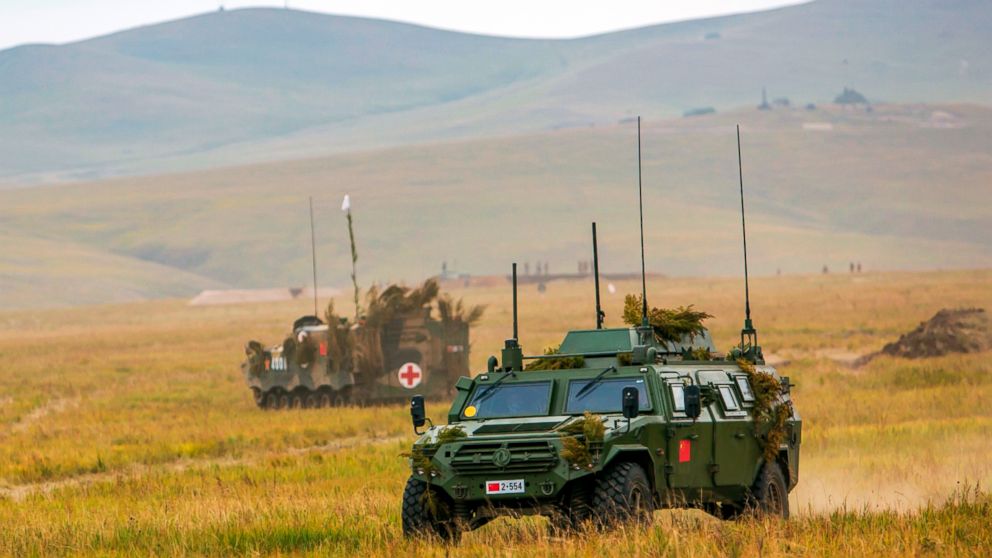 PHOTO: Chinese military vehicles through a field in Chita, Eastern Siberia, during the Vostok 2018 exercises, Sept. 11, 2018.
