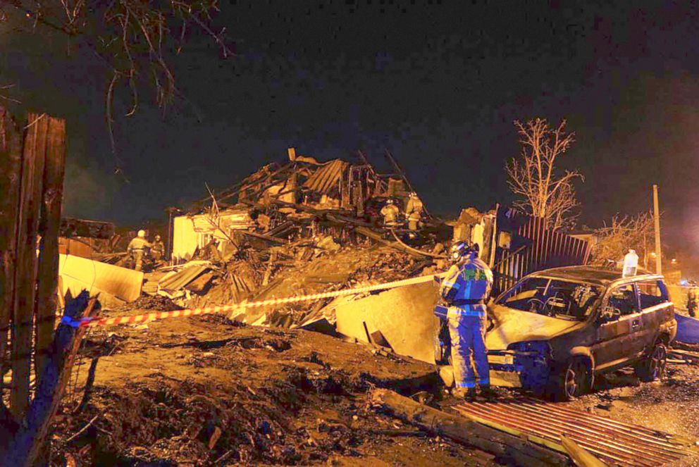 PHOTO: Firefighters work at the scene after a warplane crashed into a residential area in Irkutsk, Russia, Oct. 23, 2022