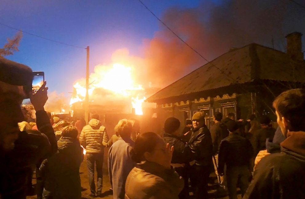PHOTO: Fire breaks out after a Sukhoi Su-30 fighter aircraft fell onto a wooden residential building near Przhevalskogo Street while performing a test flight, Oct. 23, 2022.
