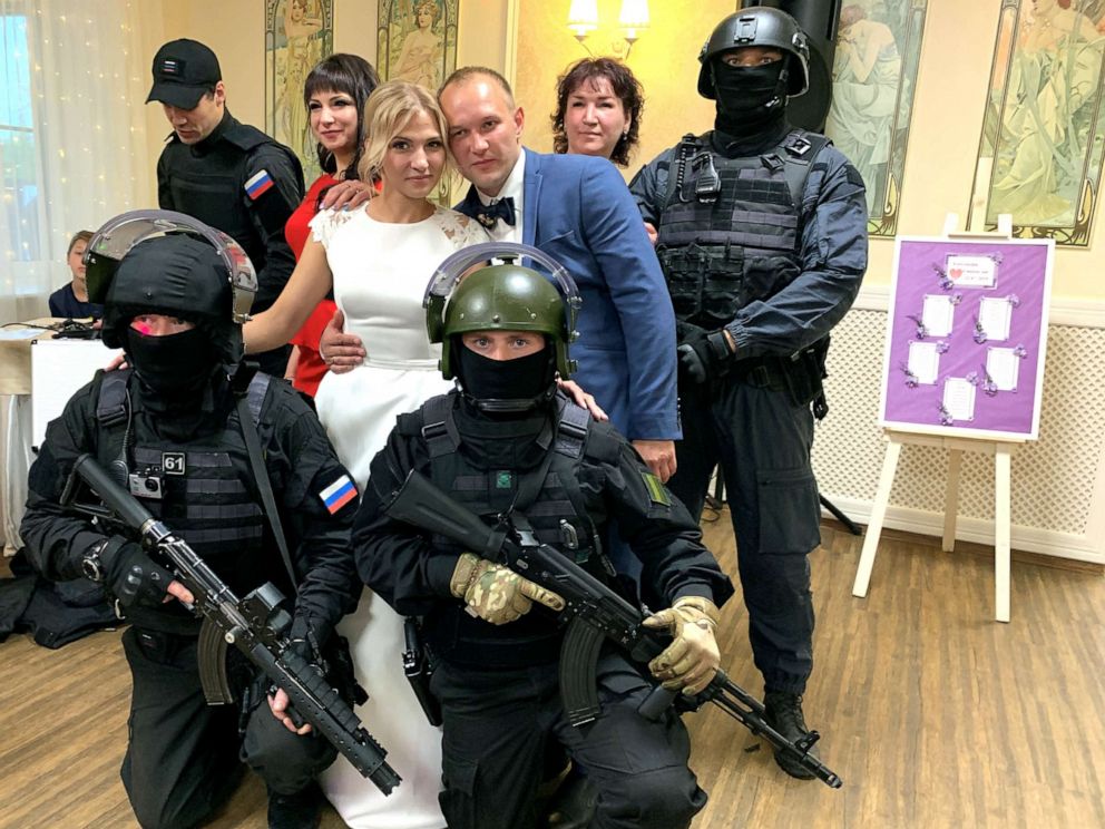 PHOTO: The bride and groom pose with imitation special forces at their wedding in Russia.