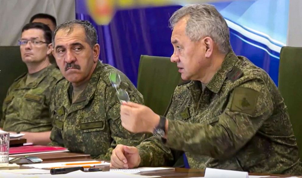 PHOTO: This photo taken from video released by the Russian Defense Ministry Press Service on July 16, 2022, shows Russian Defense Minister Sergei Shoigu, right, speaking during a meeting at an undisclosed location.