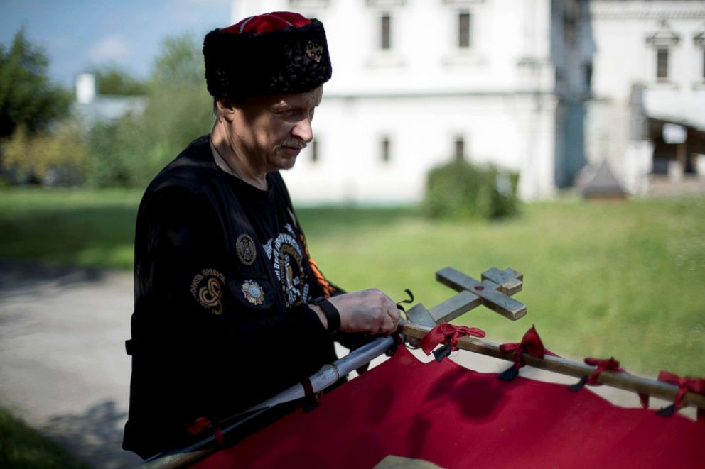PHOTO: Valeriy, a member of the Union of Orthodox Banner-Bearers, prepares a banner for a morning procession to commemorate 100 years since the killing of Tsar Nicholas II, in Spaso-Andronikov Monastery, in Moscow, July 17, 2018.