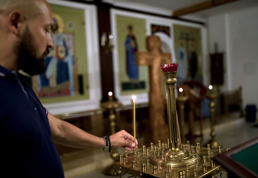 PHOTO: Denis, a member of the Union of Orthodox Banner-Bearers, visits the church inside TV and Radio Broadcasting Centre Ostankino where he works, during a break, in Moscow, July 18, 2018.