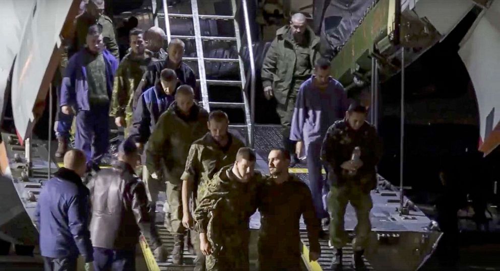 PHOTO: A group of Russian war prisoners leave a Russian military plane after they were released, in an image from video released by the Russian Defense Ministry Press Service, Sept. 22, 2022, at an unspecified location in Russia.