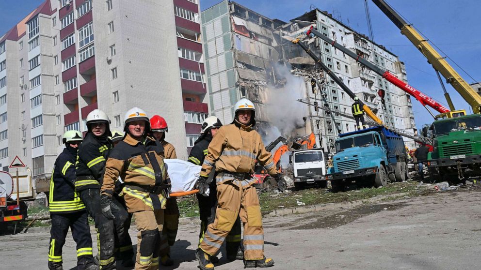 PHOTO: Rescuers carry a bag containing a body next to damaged residential buildings that were struck by Russian missiles in Uman, Cherkasy Oblast, central Ukraine, on April 28, 2023.
