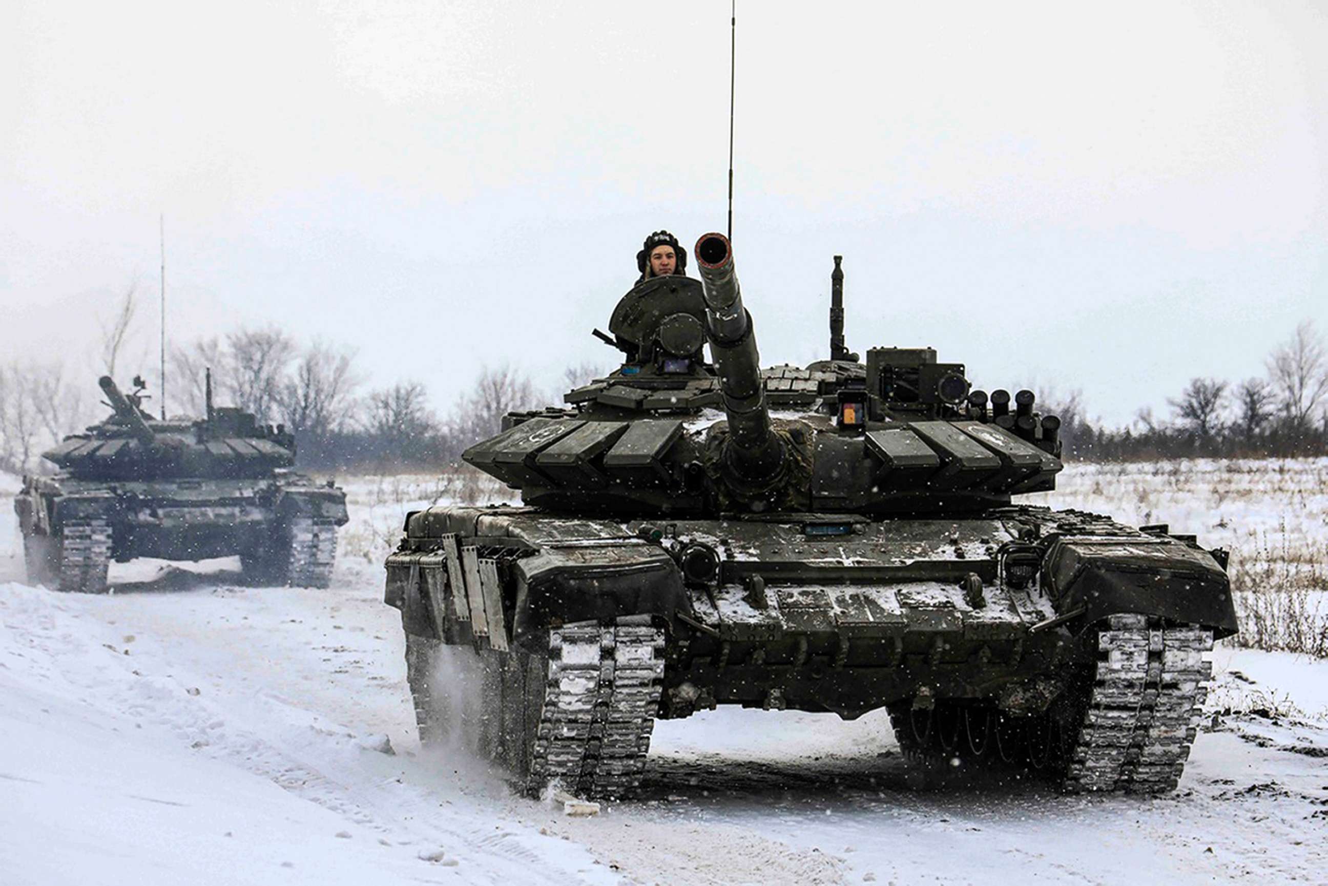 FILE PHOTO: In this photo provided by the Russian Defense Ministry Press Service on Feb. 14, 2022, Russian tanks roll on a field during military drills in Russia's Leningrad region.