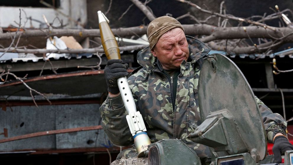 PHOTO: A service member of pro-Russian troops loads rocket-propelled grenades into an infantry combat vehicle in the southern port city of Mariupol, Ukraine, April 12, 2022.