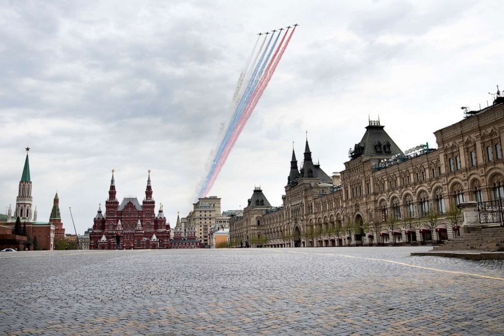 PHOTO: Russian warplanes fly over an almost empty Red Square, leaving trails of smoke in the colors of the national flag, in Moscow, Russia, on May 4, 2020.
