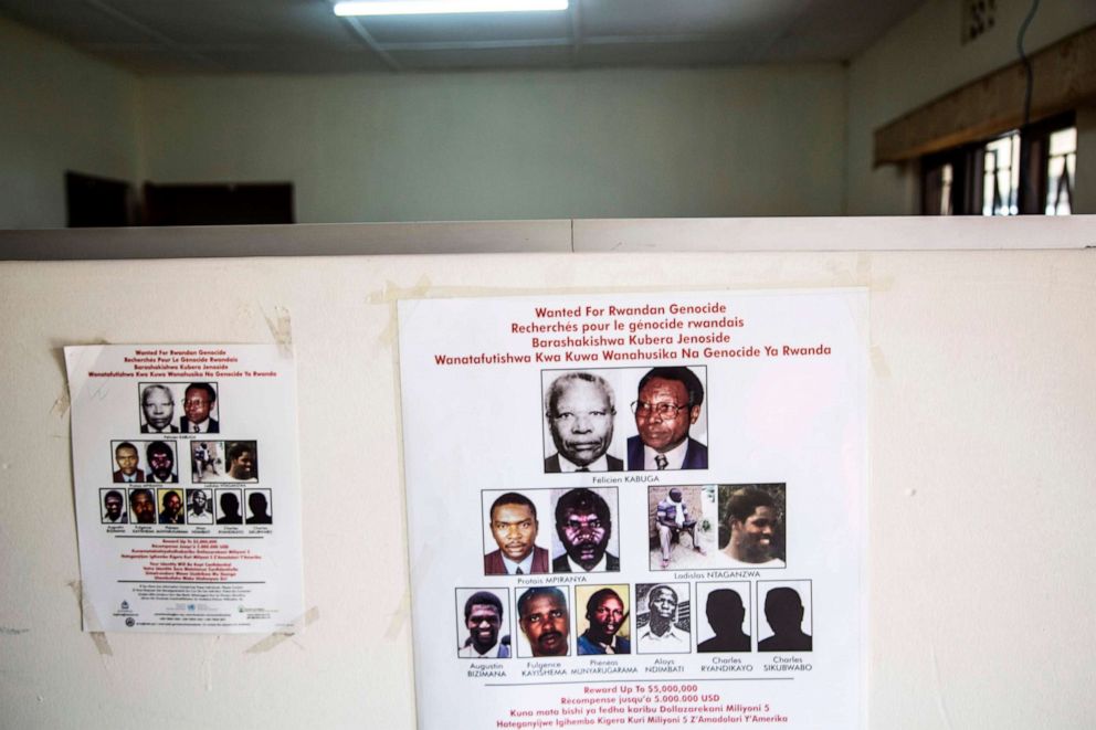 PHOTO: A placard showing names and pictures is stuck on a wall at the headquarters of the Genocide Fugitives Tracking Unit in Kigali, on March 21, 2019.