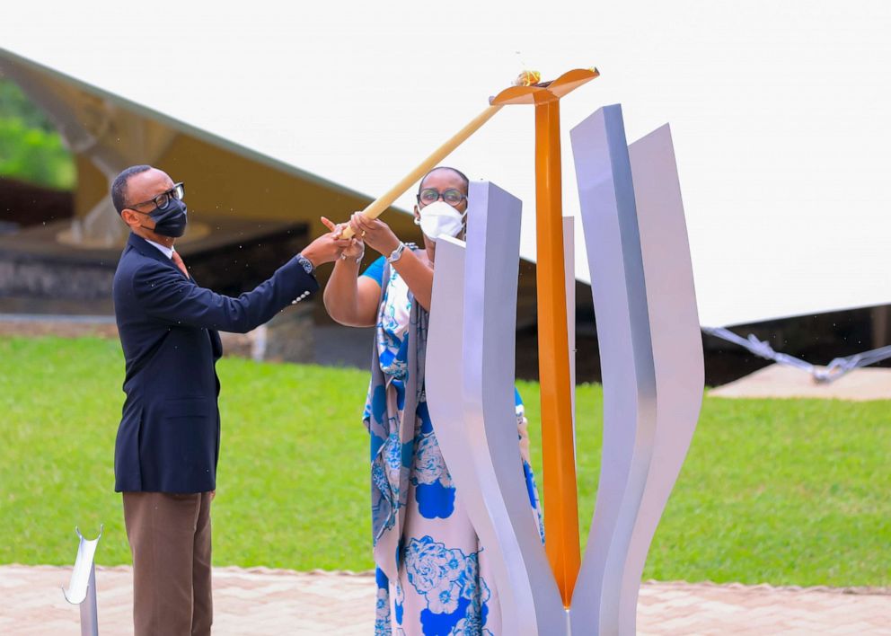 PHOTO: Rwandan President Paul Kagame and first lady Jeannette Nyiramongi Kagame light the remembrance torch, which will last 100 days, during the 27th commemoration of the 1994 genocide in Kigali, Rwanda, on April 7, 2021.
