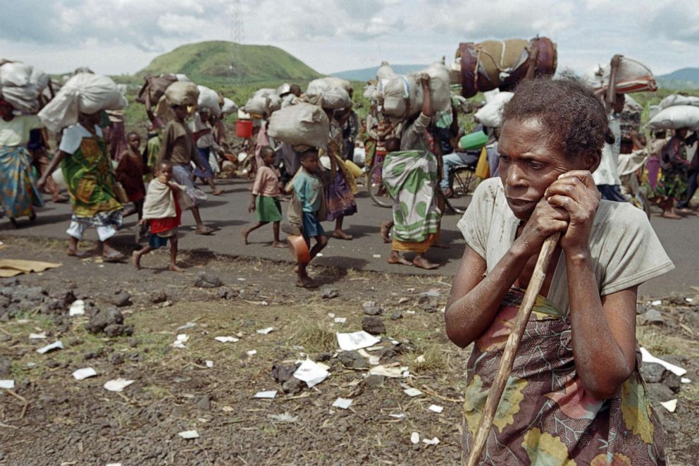 PHOTO: A woman takes a moment to rest alongside a road where hundred of thousands of Rwandan refugees coming from camps in Zaire walk toward the Rwandan border to return to their homeland on Nov. 15, 1996.