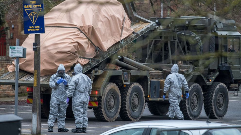 PHOTO: Military personnel wearing protective suits remove a police car and other vehicles from a public car park as they continue investigations into the poisoning of Sergei Skripal, March 11, 2018, in Salisbury, England. 