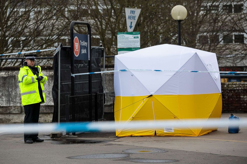 PHOTO: A police officer stands guard by a forensics tent over a pay and display machine in a Sainsbury's car park as investigations continue into the poisoning of Sergei Skripal, March 13, 2018, in Salisbury, England.