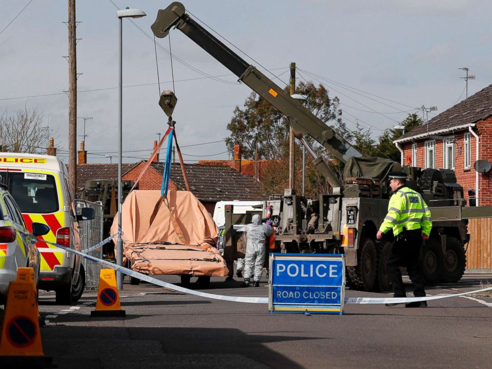 PHOTO: British Military personnel wearing protective coveralls work to remove a vehicle connected to the March 4 nerve agent attack in Salisbury, from a residential street in Gillingham, southeast England on March 14, 2018.
<p itemprop=