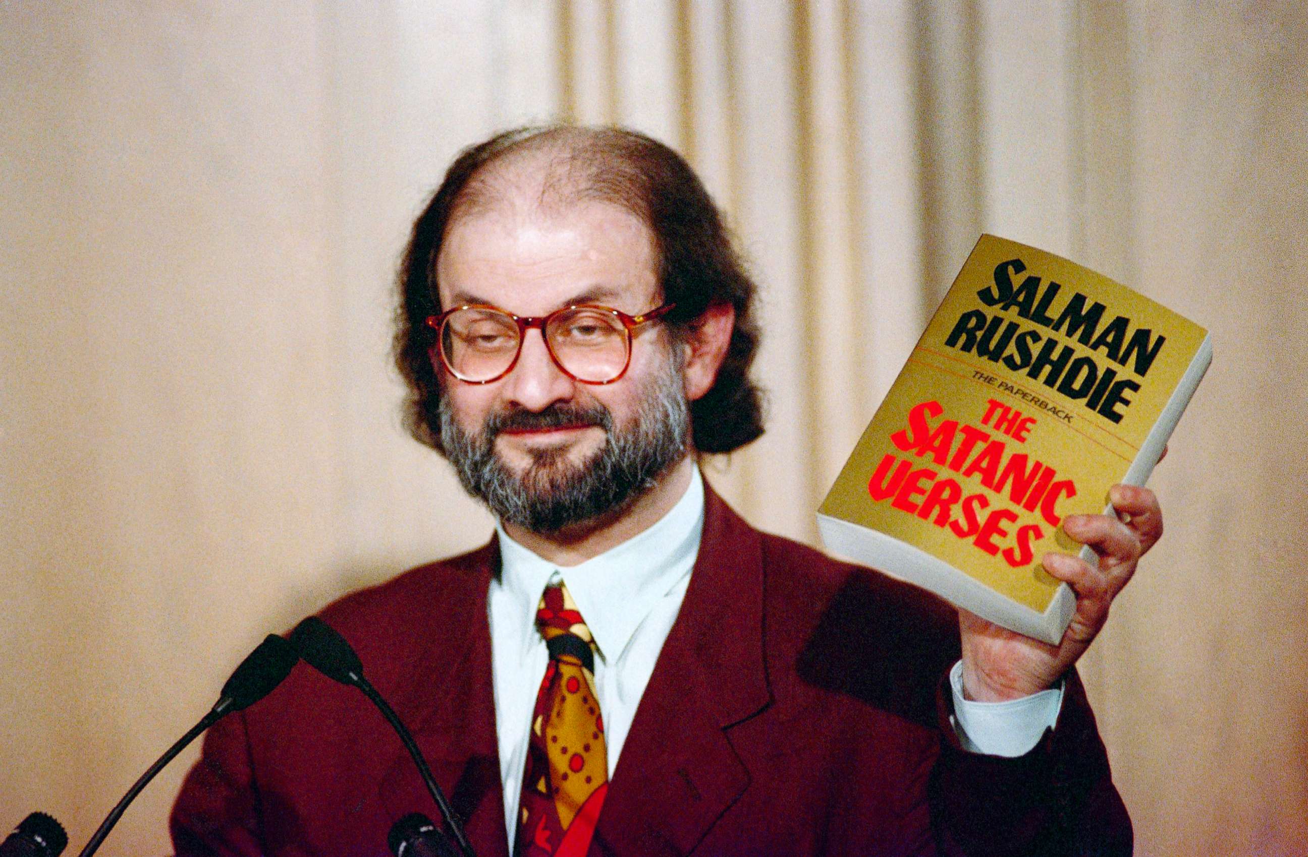 PHOTO: Salman Rushdie holds up a copy of his book "The Satanic Verses" at Freedom Forum in Arlington, Va., March 1992. 