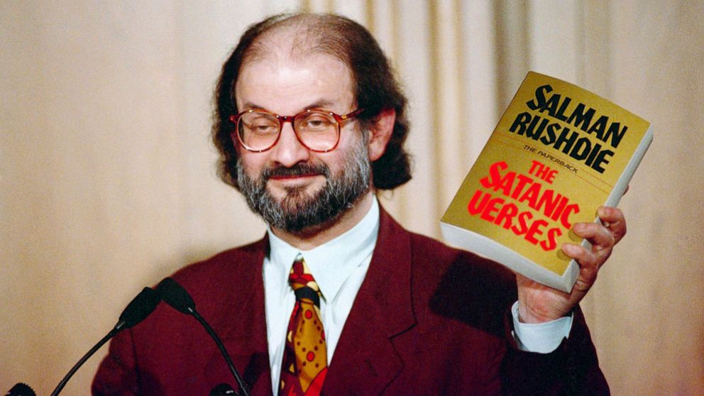 PHOTO: Salman Rushdie holds up a copy of his book "The Satanic Verses" at Freedom Forum in Arlington, Va., March 1992. 