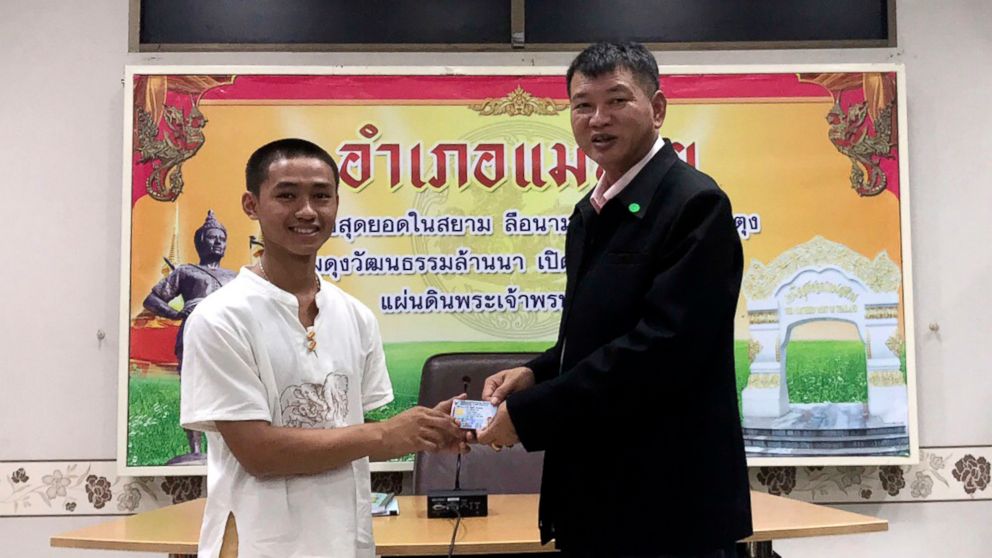 PHOTO: Adul Sam-on, left, receives an identity card denoting Thai citizenship from Somsak Kunkam, Sheriff of Mae Sai during a ceremony in Chiang Rai province, Thailand, Aug. 8, 2018.