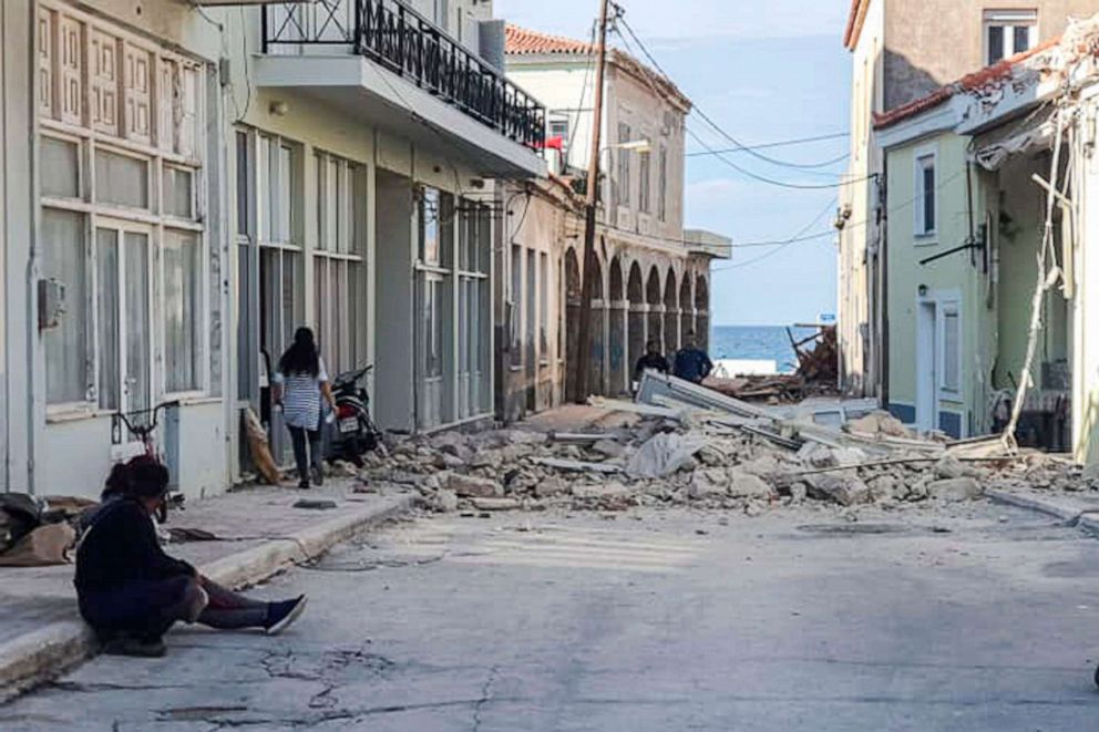 PHOTO: People walk past a destroyed house after an earthquake in the island of Samos, Greece, Oct. 30, 2020.