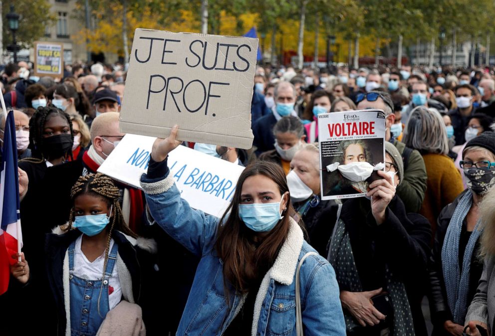 PHOTO: People gather at the Place de la Republique in Paris, to pay tribute to Samuel Paty, the French teacher who was beheaded on the streets of the Paris suburb of Conflans-Sainte-Honorine, France, Oct. 18, 2020.