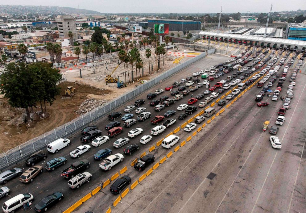 PHOTO: An aerial view of Mexico's old customs facilities (above), next to the construction site of an expansion of the crossing lanes at San Ysidro Port of Entry on the U.S.-Mexico border in Tijuana, Baja California state, Mexico, on July 27, 2020.