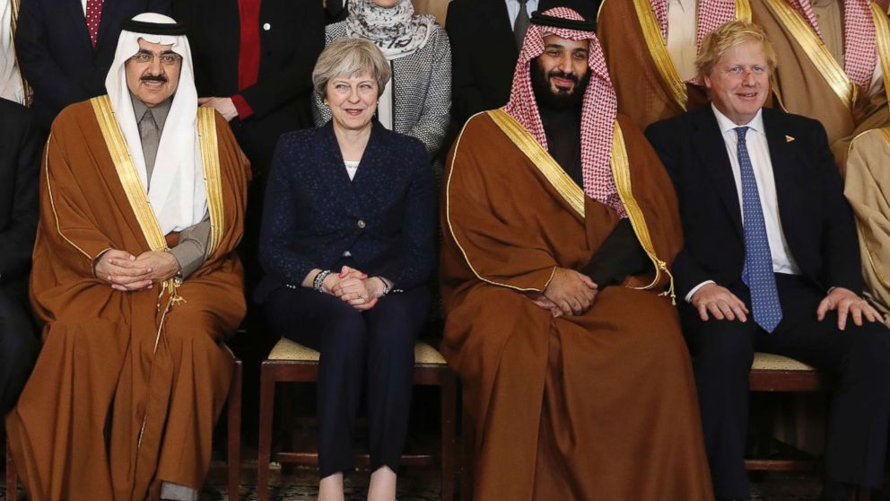 Britain's Prime Minister Theresa May, 2nd left, sits with Saudi Crown Prince Mohammed bin Salman, 2nd right, and other members of the British government and Saudi ministers and delegates inside 10 Downing Street in London, March 7, 2018, for a group photo.
