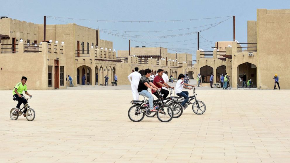 PHOTO: In this file photo, children ride their bicycles at the reconstructed historical quarter of Awamiya, a Shiite-majority town on Saudi Arabia's oil-rich eastern coast on April 28, 2019.