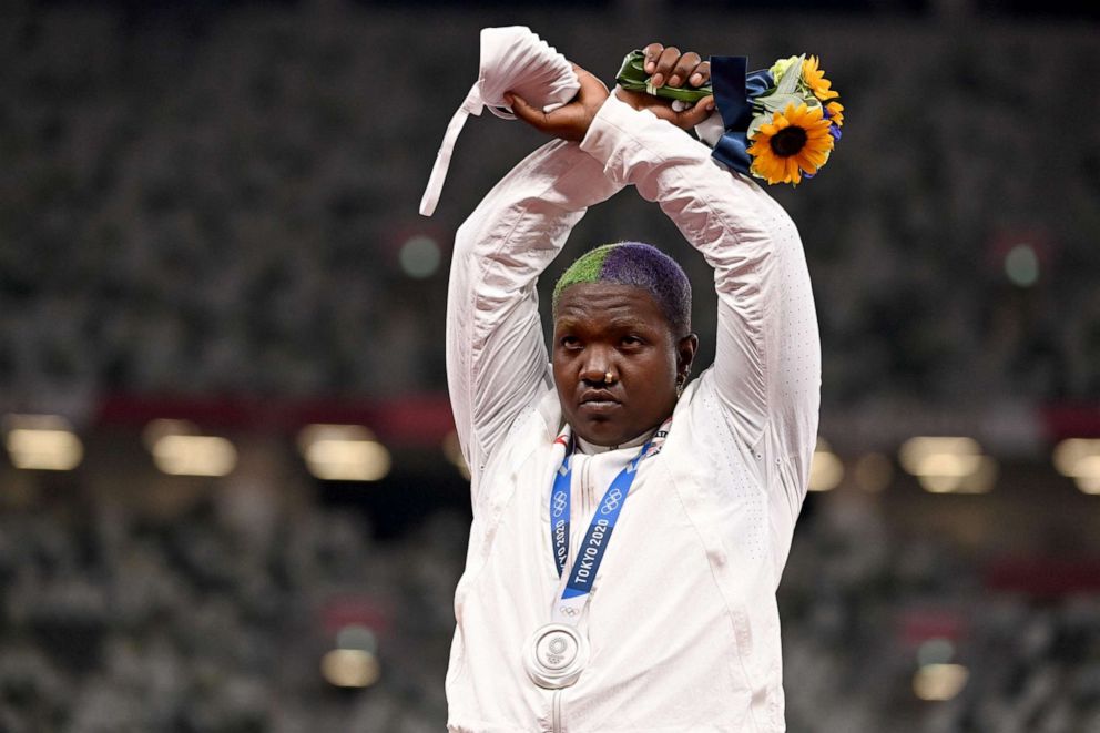 PHOTO: Raven Saunders gestures on the podium with her silver medal after wining the women's shot put event during the Tokyo 2020 Olympic Games at the Olympic Stadium in Tokyo on Aug. 1, 2021.