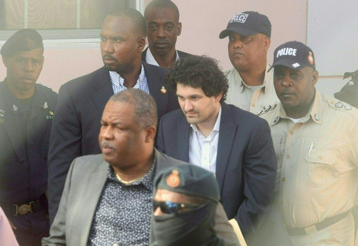 PHOTO: FTX founder Sam Bankman-Fried is led away handcuffed by officers of the Royal Bahamas Police Force at the Nassau, Bahamas, courthouse on Dec. 19, 2022.