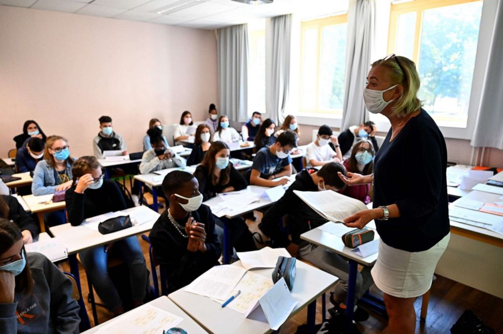 PHOTO: A teacher with protective mask speaks to pupils in a classroom in Brequigny high school in Rennes, western France, on Sept. 1, 2020, on the first day of the school year amid the COVID-19 epidemic.