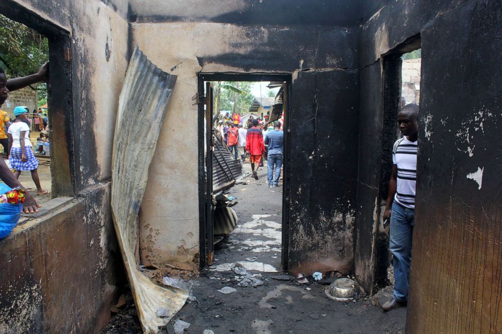 PHOTO: A man looks into a burned building after a fire swept through a school on the outskirts of Monrovia, Liberia, Sept. 18, 2019.