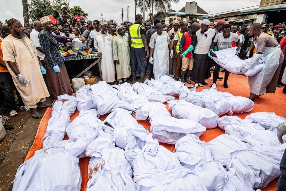 PHOTO: After being made ready for burial, men lay one of many bodies who were killed in an overnight fire at a Koranic school, on plastic sheeting as they are prepared for burial, in Monrovia, Sept. 18, 2019.