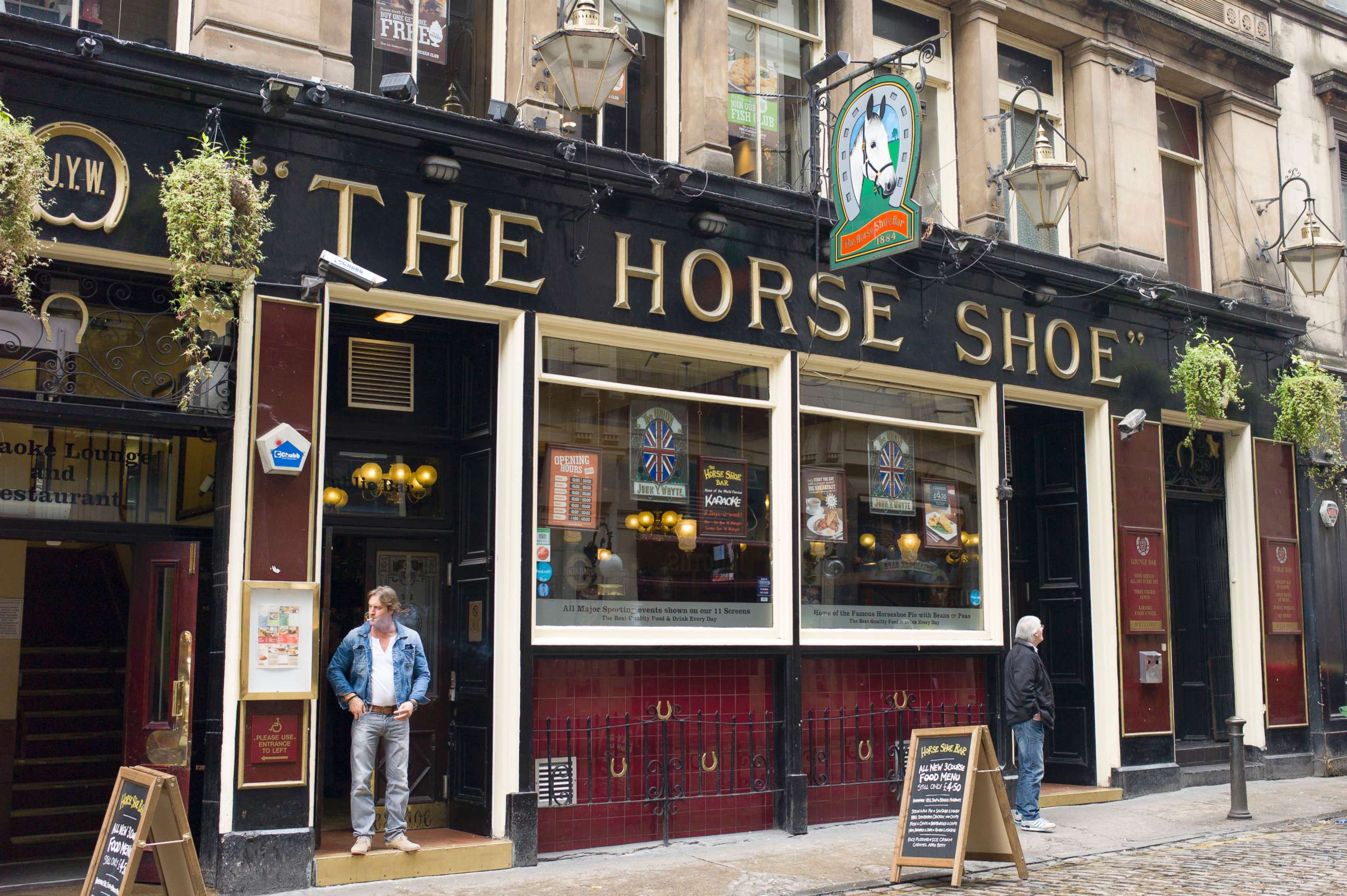 PHOTO: In this file photo, customers at the Horse Shoe public house, a traditional pub on Drury Street off Buchanan Street, in Glasgow, Scotland, May 2014.