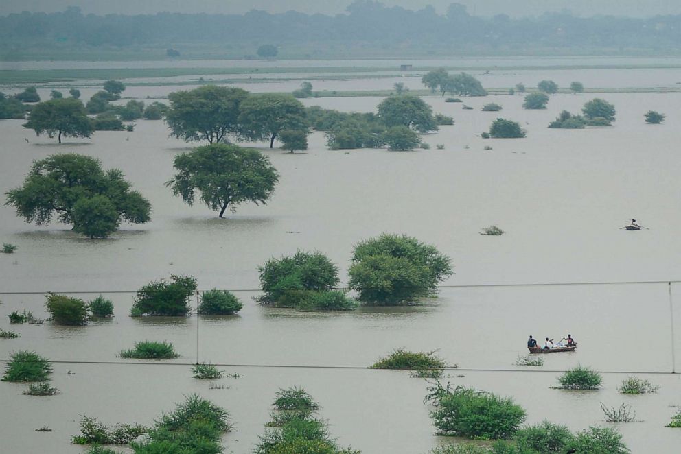 PHOTO: This file photo taken on August 21, 2019, shows an aerial view of villagers using boats to cross a flooded River Ganges as water levels in the Ganges and Yamuna rivers rise, in Allahabad.
