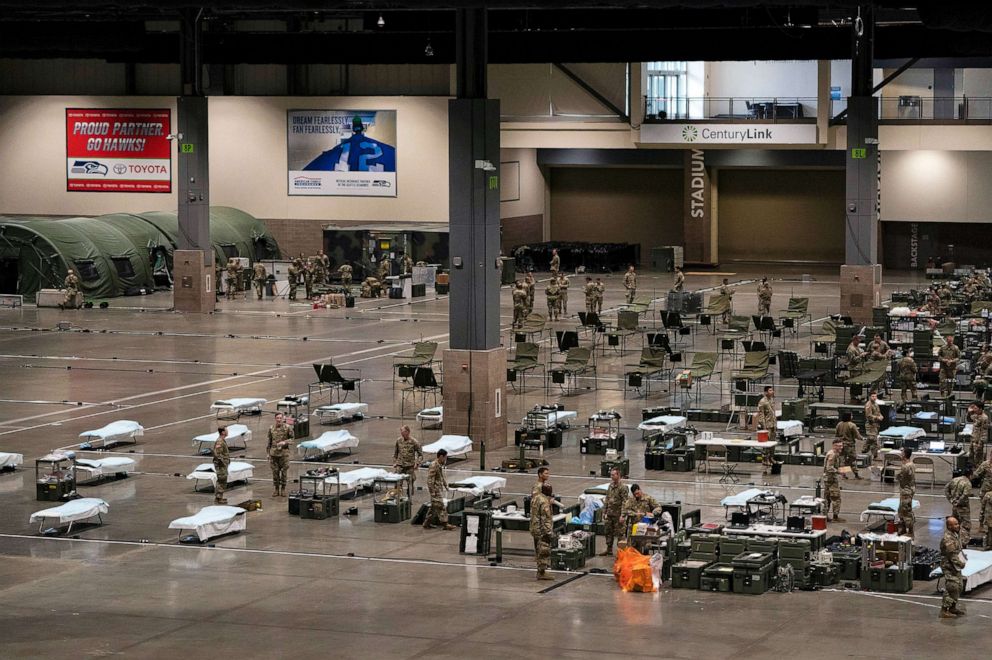 PHOTO: Army soldiers from Joint Base Lewis McCord and Fort Carson build a field hospital at the Century Link Event Center in Seattle, March 31, 2020.