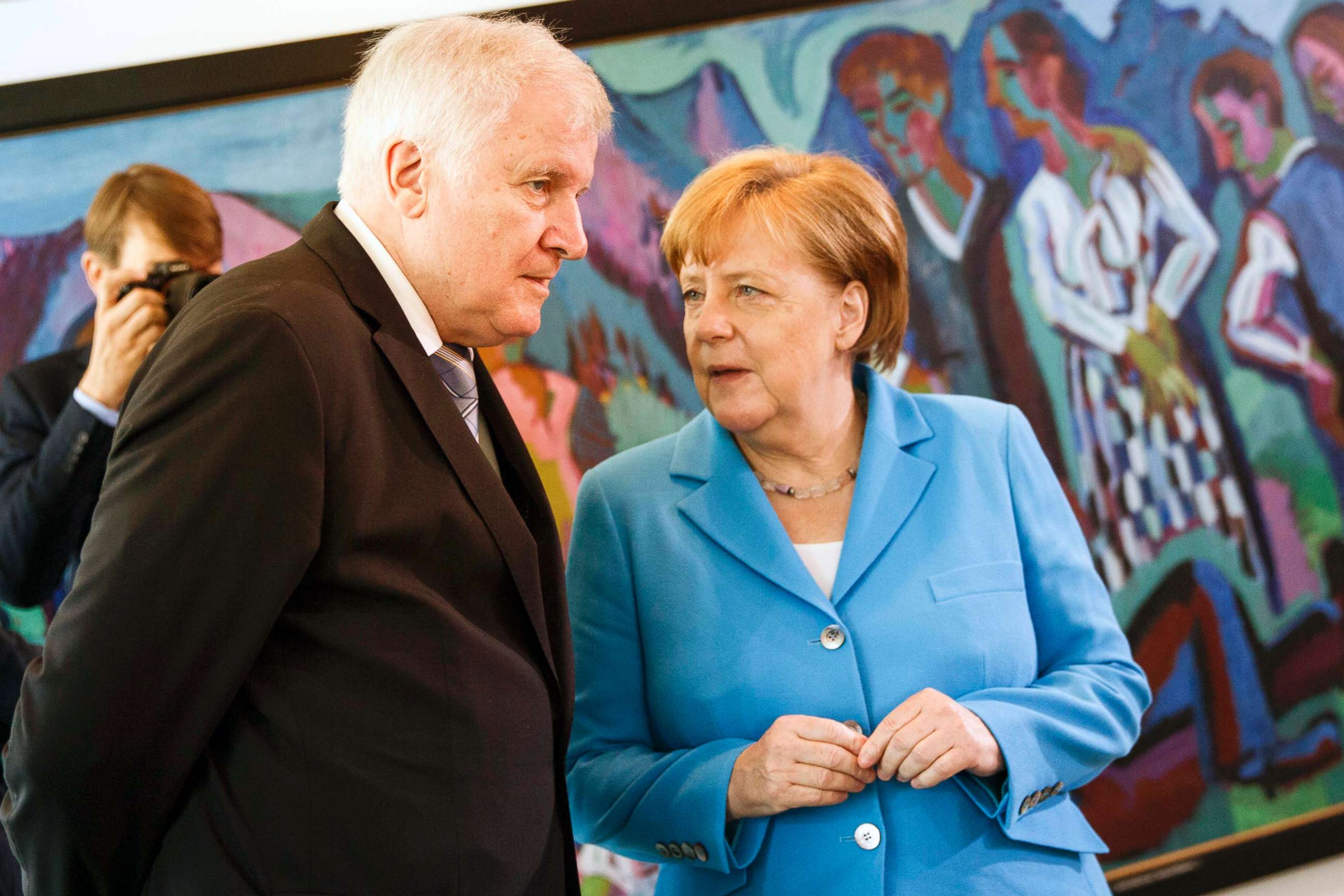 PHOTO: German Chancellor Angela Merkel speaks to German Interior Minister Horst Seehofer after the arrival for the weekly government cabinet meeting, June 13, 2018, in Berlin.
