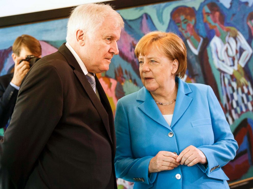 PHOTO: German Chancellor Angela Merkel speaks to German Interior Minister Horst Seehofer after the arrival for the weekly government cabinet meeting, June 13, 2018, in Berlin.