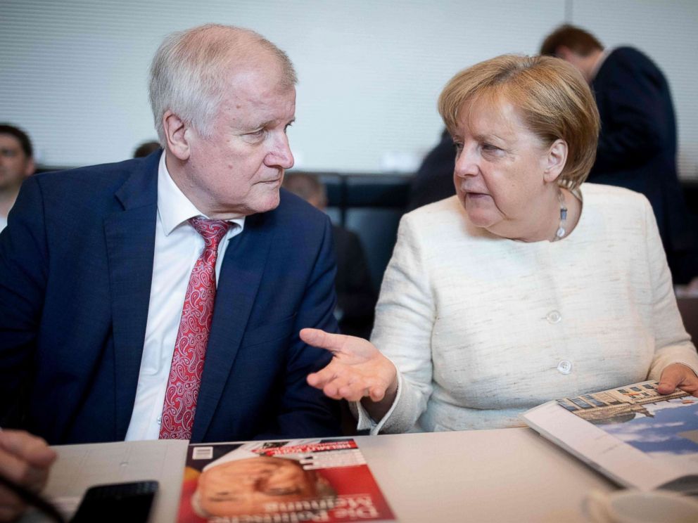 PHOTO: German Chancellor and leader of the Christian Democratic Union (CDU) party Angela Merkel talks with German Interior Minister Horst Seehofer (CSU) prior a parliamentary group meeting, June 12, 2018, in Berlin.